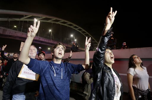 Protesters block highway, stop train in California