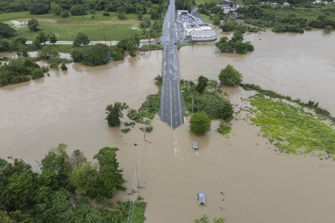 Hurricane Ernesto drops torrential rain on Puerto Rico as it strengthens heading toward Bermuda