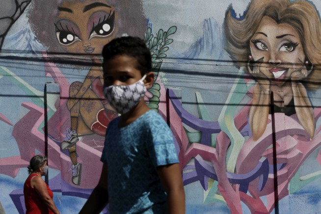 The Latest: Trump says he's 'getting used to' wearing mask