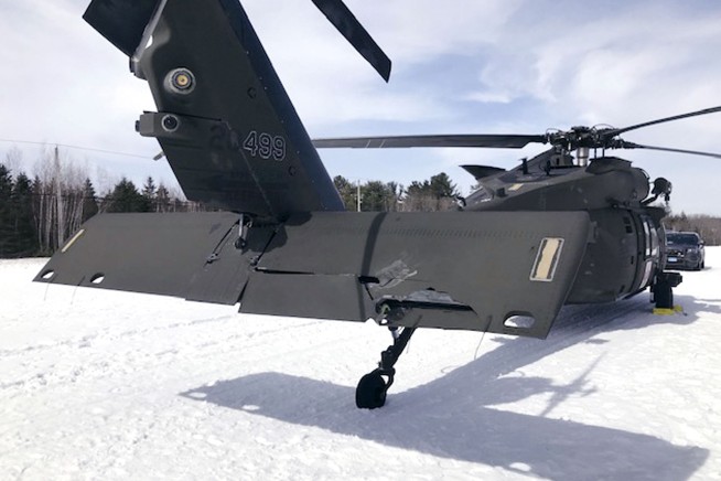 A man who crashed a snowmobile into a parked Black Hawk helicopter is suing the government for $9.5M