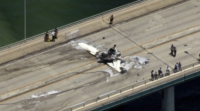 Small plane crashes on bridge near Miami, striking an SUV