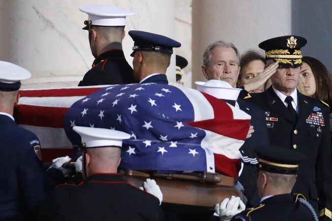 The Latest: Trump salutes Bush's casket in Capitol Rotunda