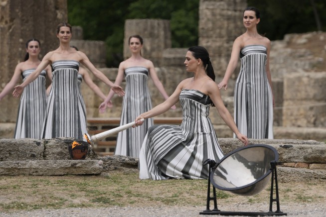 Despite weather glitch, the Paris Olympics flame is lit at the Greek cradle of ancient games