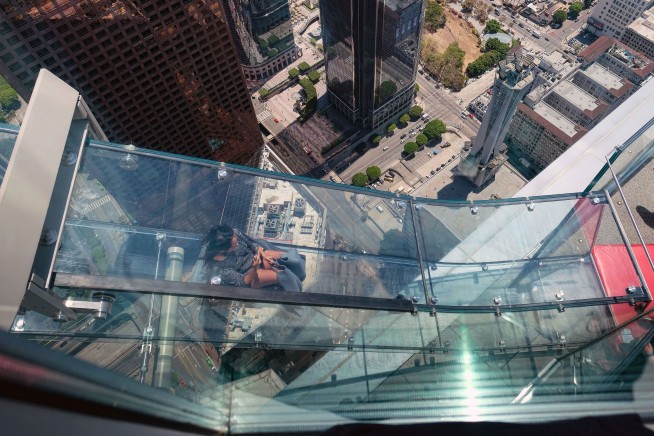 AP reporter's terrifying trip on 1,000-foot-high glass slide