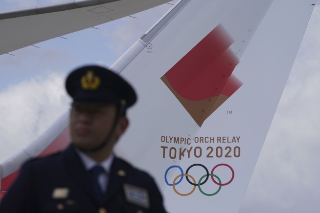 Olympic flame lands in Japan as doubts grow over Tokyo Games