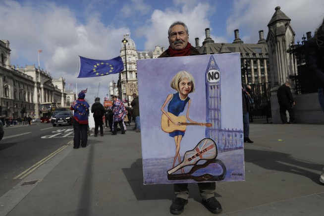 The Latest: British lawmakers reject leaving EU with no deal