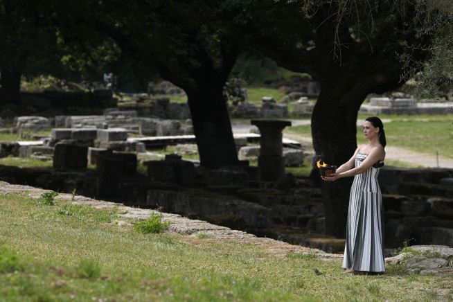 Despite weather glitch, the Paris Olympics flame is lit at the Greek cradle of ancient games