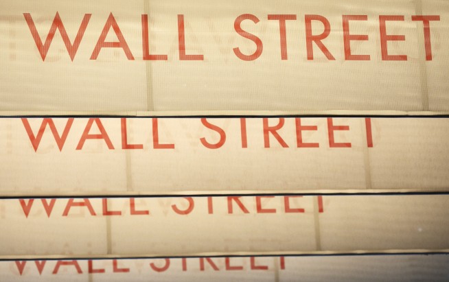 Wall Street ends a bumpy day modestly higher but yields fall