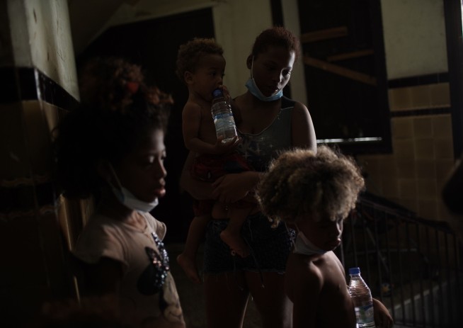 The Latest: Philippine capital sets restrictions amid surge