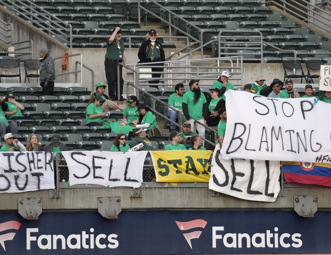 A's met by fans in Oakland with chants of `Sell the team!'