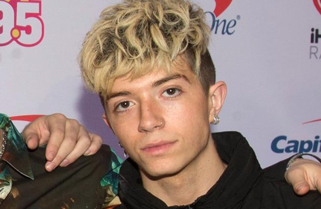 Ex-girlfriend of boy band member charged with trying to hire a hitman to kill him