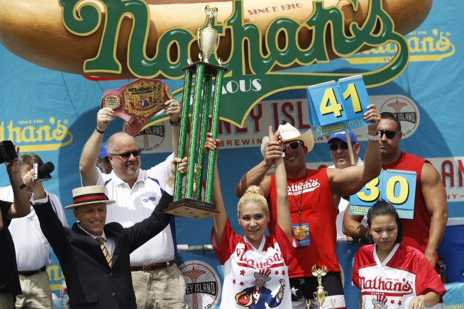 The Latest: 5 people taken into custody at hot dog contest