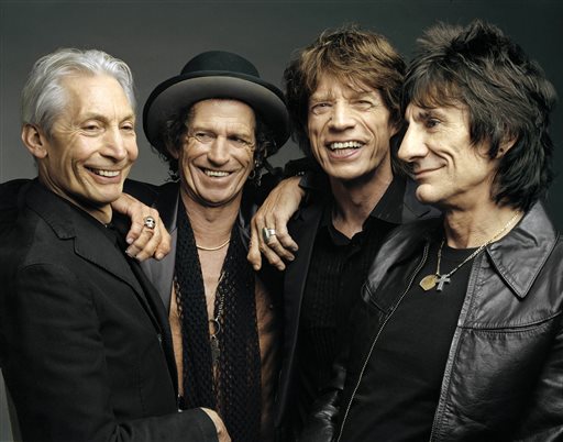 Jagger pays tribute to companion, Stones halt tour