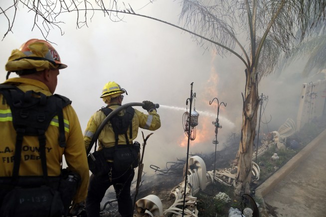 Wind-whipped fires rage across California as lights go out