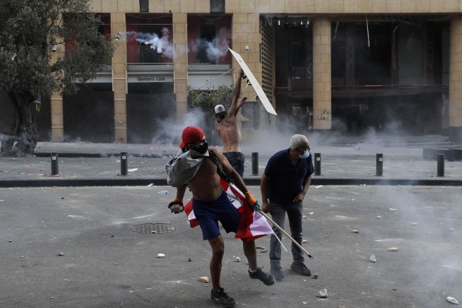 Tear gas, clashes in Beirut amid fury over massive blast