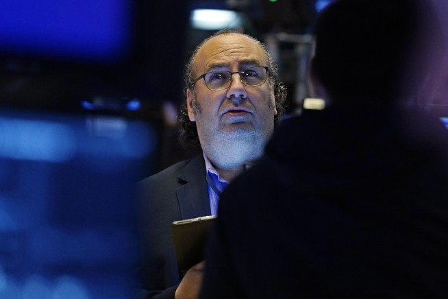 Stocks end a wobbly day mixed and just shy of record highs