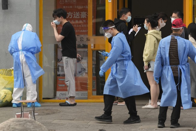 Shanghai discharges thousands of patients, boosts supplies