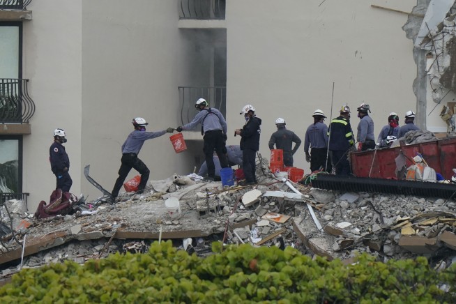 Safety concerns halt rescue efforts at condo collapse site
