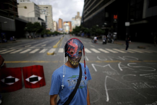 Venezuela leader's foes levy new sanctions and fresh strike