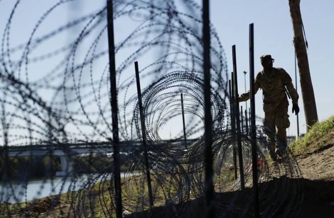 Migrants won't see armed US soldiers on border