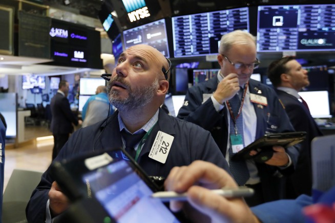 Stocks end a wobbly day lower, edging below recent records