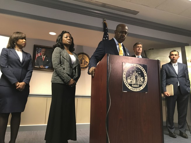 Prosecutor sues Justice Department over man shot 59 times