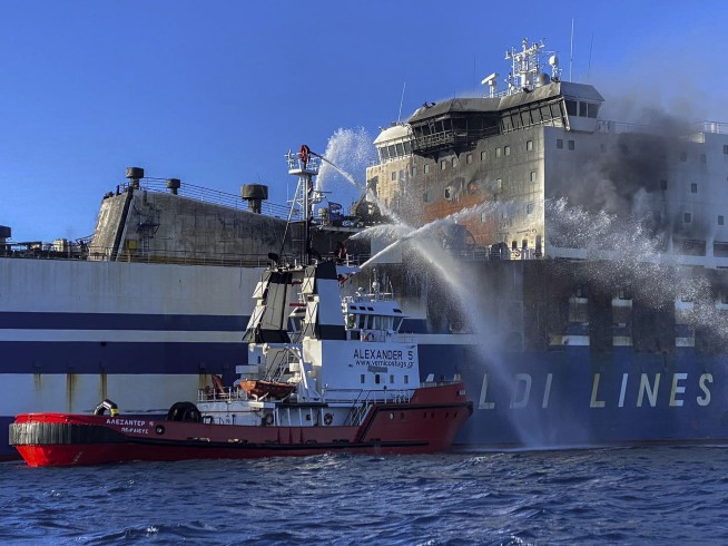 Greek rescuers search burning ferry for 12 missing people