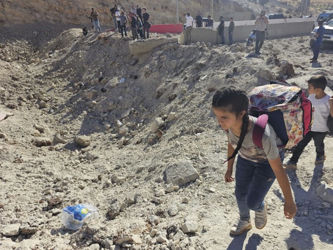 Israeli airstrikes rock southern suburbs of Beirut and cut off a key crossing into Syria