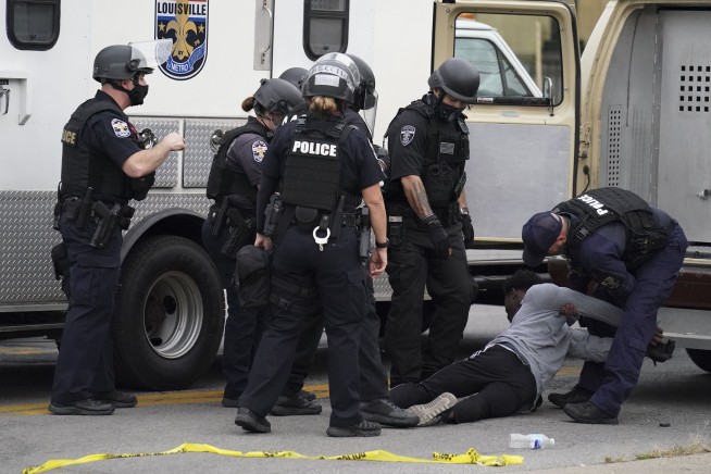 The Latest: Man has been charged with shooting 2 officers