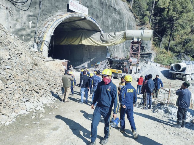Rescuers dig to reach 40 workers trapped in collapsed road tunnel in north India