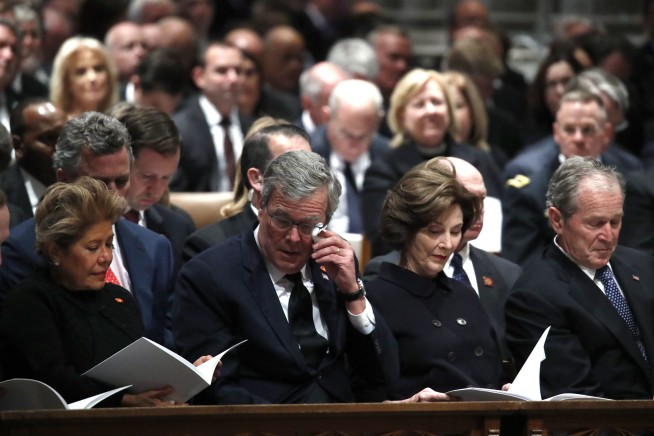 Trump on the fringes of presidents' group at Bush's service