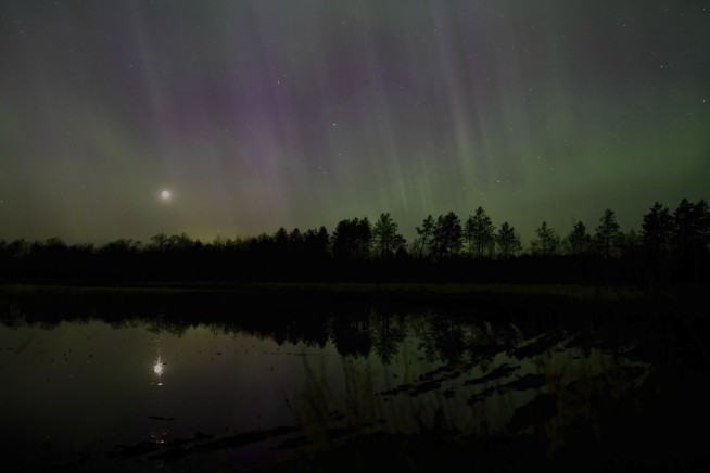 Solar storm hits Earth, producing colorful light shows across Northern Hemisphere