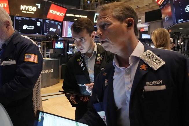 Wall Street falls in a manic day after briefly dropping more than 10% below its record