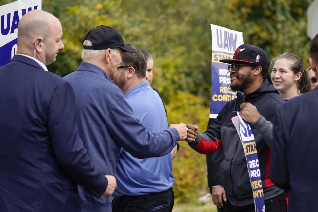 Biden urges striking auto workers to 'stick with it' in picket line visit unparalleled in history