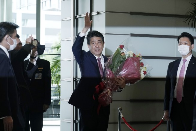 Shinzo Abe, powerful former Japan PM, leaves divided legacy