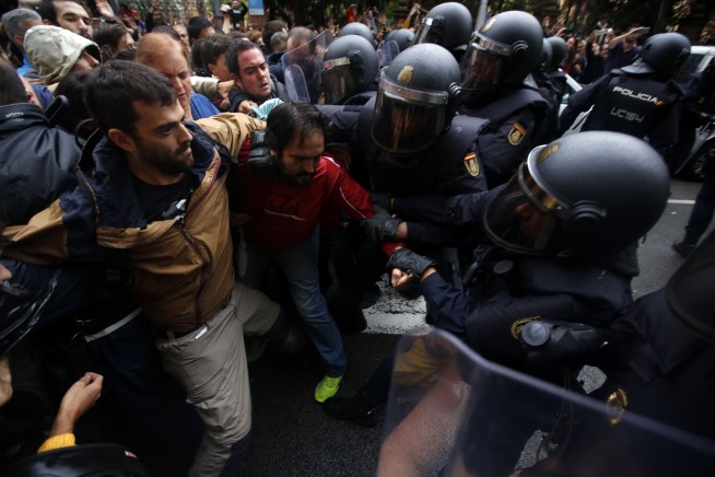 The Latest: Spanish police beat, kick people in Catalonia