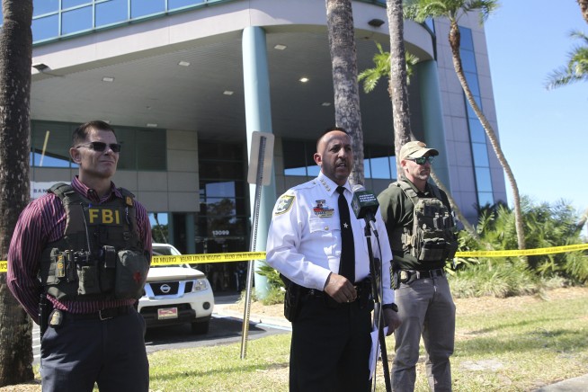 A sniper killed a Florida bank robber as he held a knife to a hostage's throat