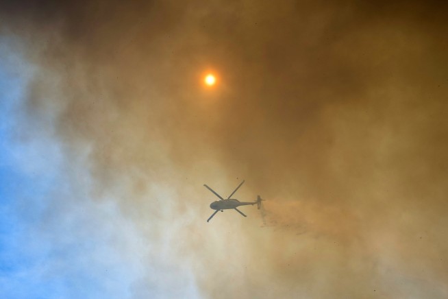 Firefighters helped by cooler weather battle blaze that has scorched area size of Los Angeles