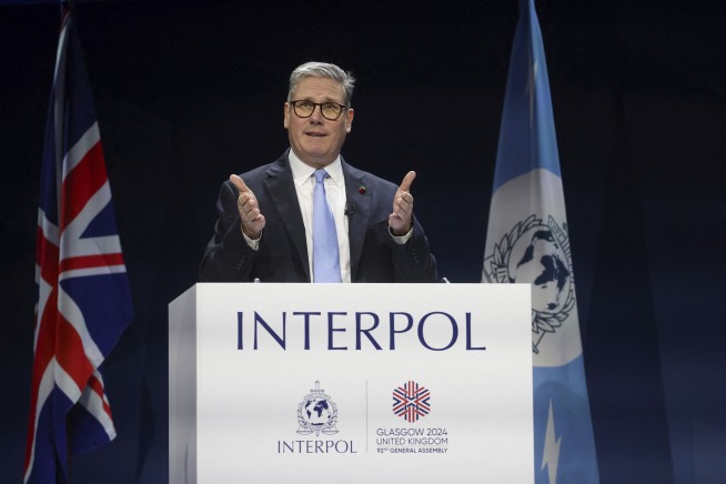 UK leader tells Interpol meeting world must 'wake up' to threat from people-smugglers