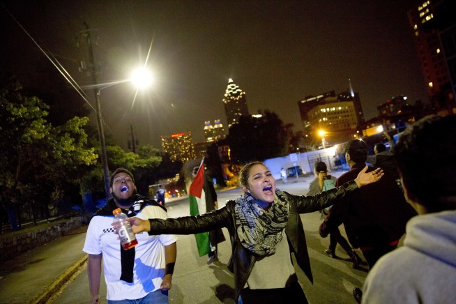 Anti-Trump protesters march amid tear gas, flash grenades