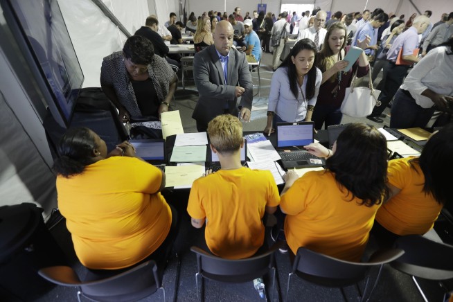 US employers add 148,000 jobs, jobless rate stays 4.1 pct.