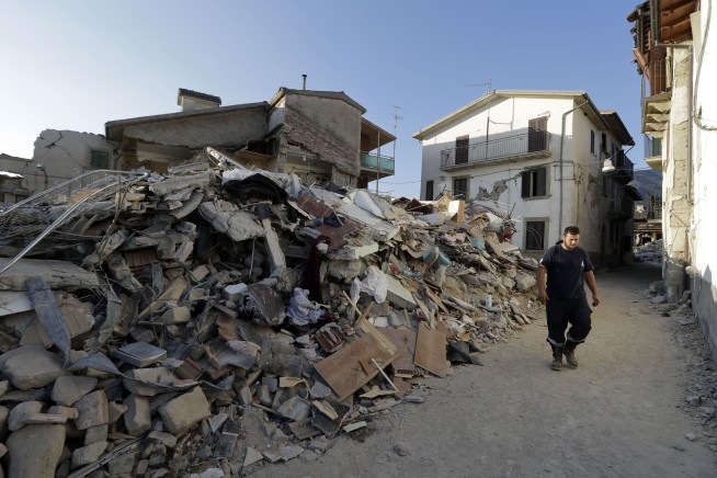The Latest: Italy lowers quake death toll back to 290