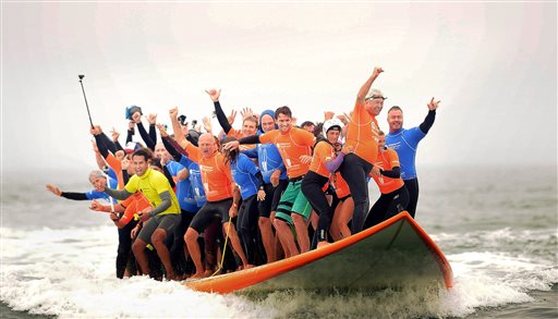 66 Surfers Crowd Onto Board to Break World Record