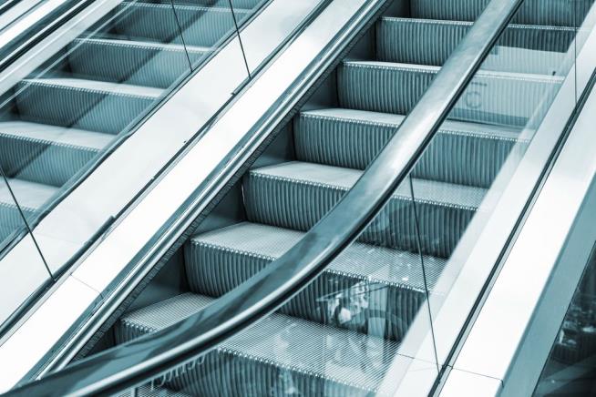 Mom Saves Her Kid as She's Crushed to Death by Escalator