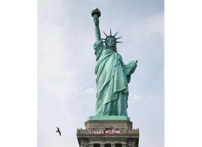 'Refugees Welcome' Banner Draped on Statue of Liberty