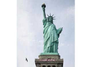 'Refugees Welcome' Banner Draped on Statue of Liberty