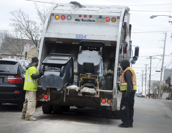 Fighterfighters Rescue Man From Garbage Truck