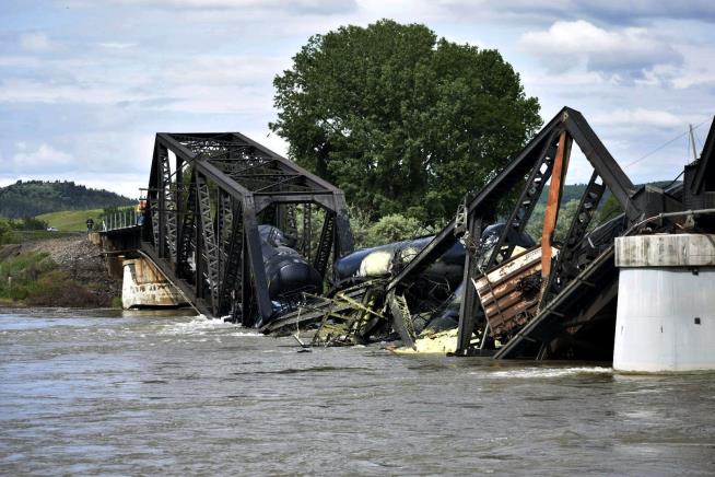 Freight Cars Fall Into River as Bridge Collapses