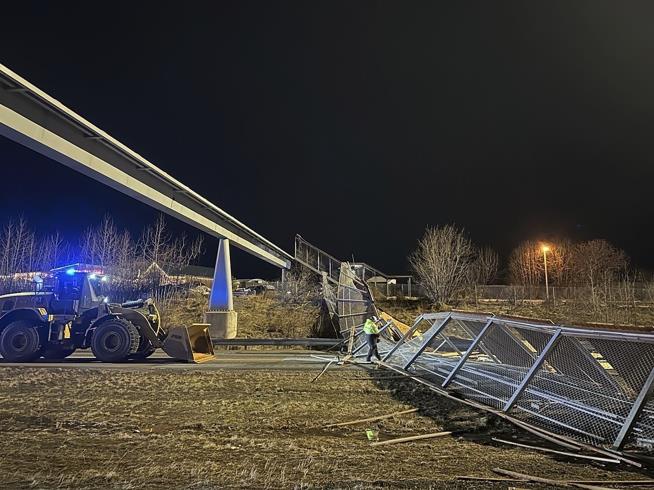 Strong Winds Topple Bridge Fencing, Blocking Highway