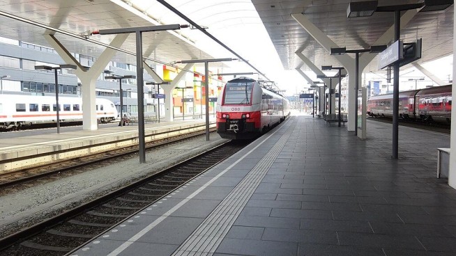As High-Speed Train Departs, Man Grabs On